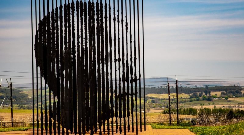 black metal fence on brown field